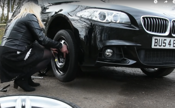woman changing car tyre with the oad hero space saver kit