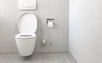 wall mounted toilet in a white tiled WC
